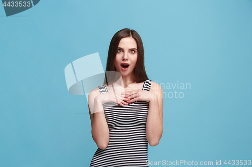 Image of Beautiful woman looking suprised isolated on blue
