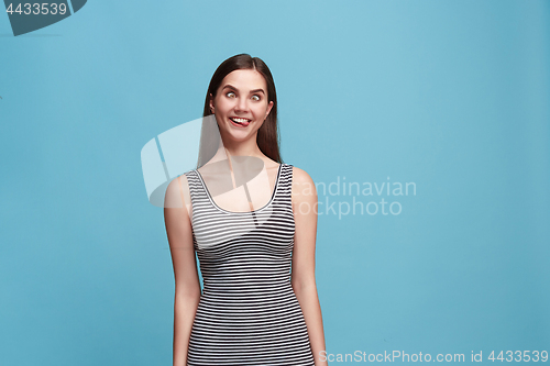 Image of The squint eyed woman with weird expression isolated on blue
