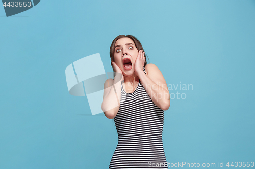 Image of Portrait of the scared woman on blue