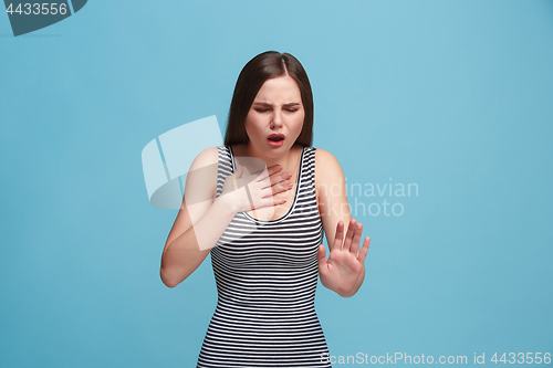 Image of Young woman overwhelmed with a pain in the throat