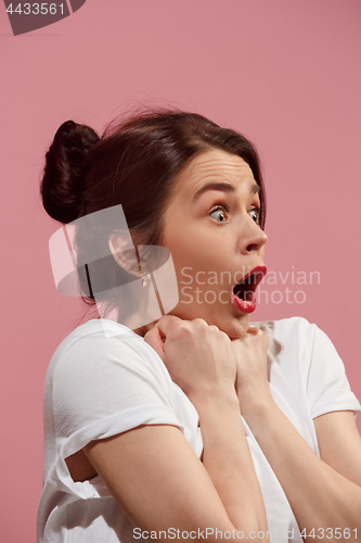 Image of Beautiful woman looking suprised isolated on pink