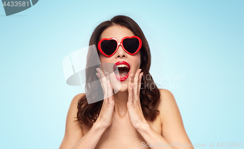 Image of woman with red lipstick and heart shaped shades