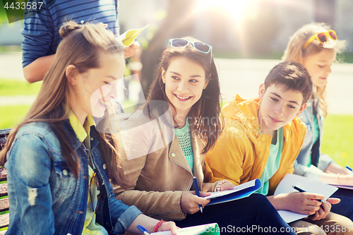 Image of group of students with notebooks at school yard