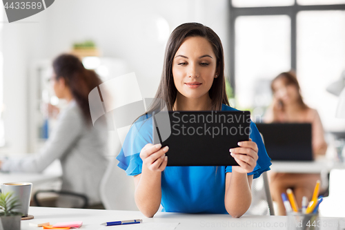 Image of businesswoman with tablet pc working at office