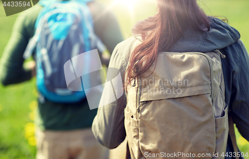 Image of close up of couple with backpacks hiking outdoors