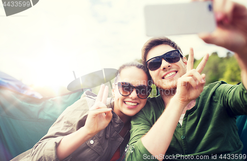 Image of couple of travelers taking selfie by smartphone