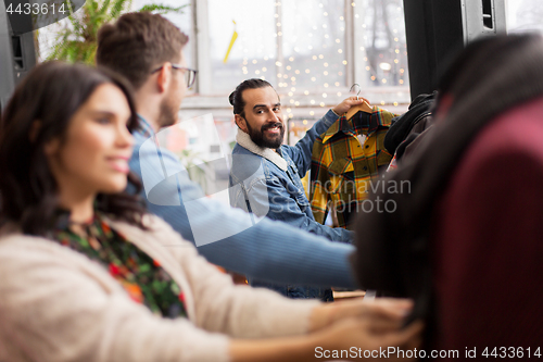 Image of friends choosing clothes at vintage clothing store