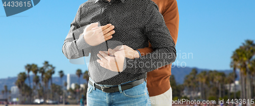 Image of close up of hugging male gay couple