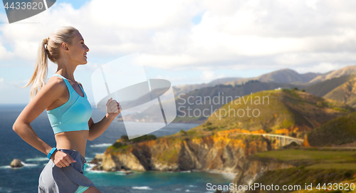 Image of woman with fitness tracker running outdoors