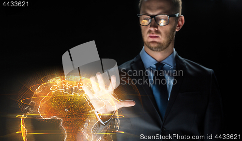 Image of close up of businessman with earth hologram