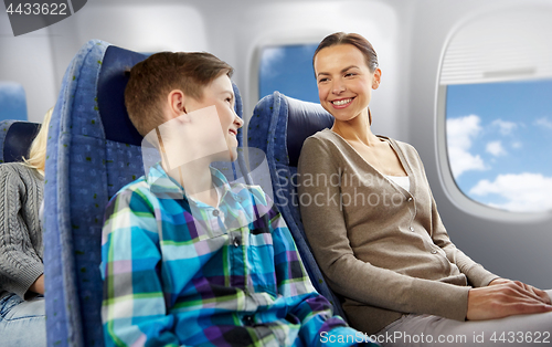 Image of happy mother and son traveling by plane