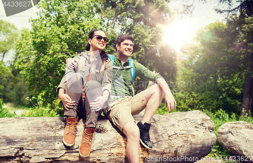 Image of smiling couple with backpacks in nature