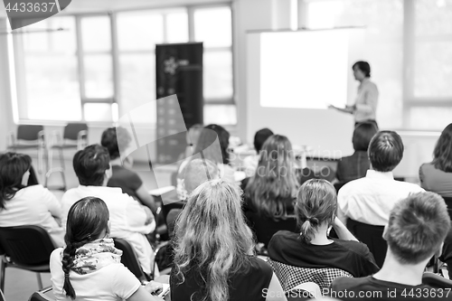 Image of Speaker giving presentation on business conference.