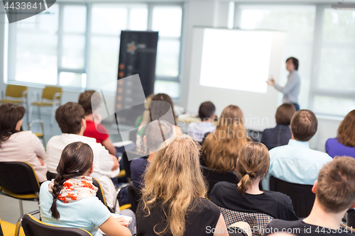 Image of Speaker giving presentation on business conference.