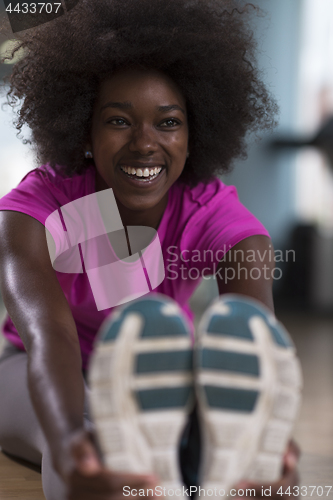 Image of woman in a gym stretching and warming up before workout