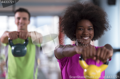 Image of couple  workout with weights at  crossfit gym