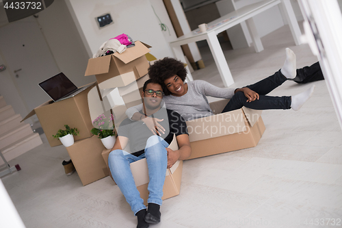 Image of African American couple  playing with packing material