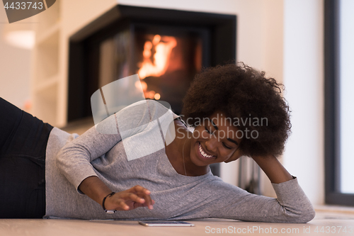 Image of black women using tablet computer on the floor