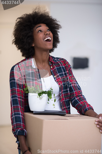 Image of Black girl moving in the new apartment