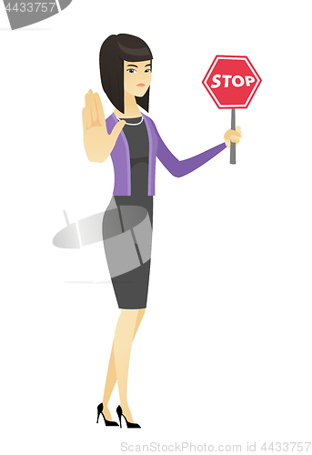 Image of Asian business woman holding stop road sign.