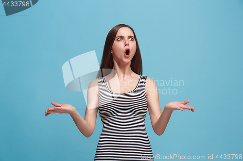 Image of Portrait of an argue woman looking at camera isolated on a blue background