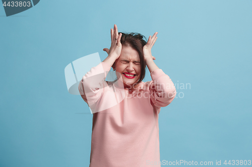 Image of Beautiful woman in stress isolated on blue