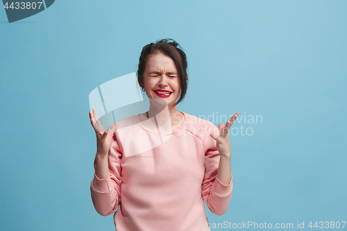 Image of Beautiful woman in stress isolated on blue