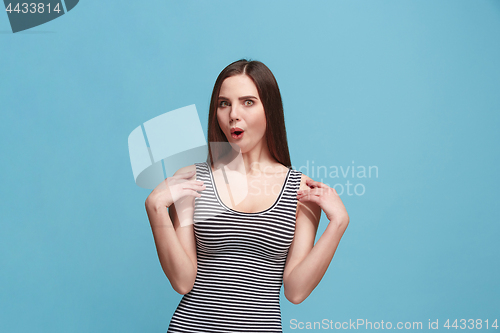 Image of Beautiful woman looking suprised isolated on blue