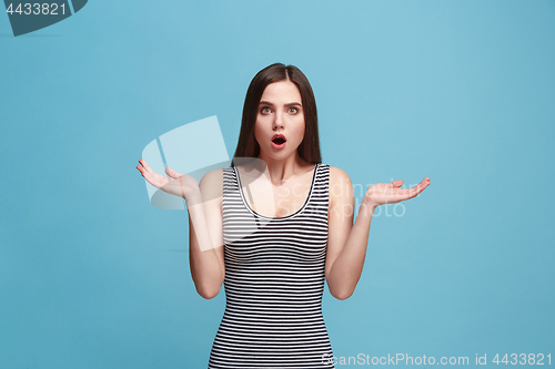 Image of Beautiful woman looking suprised isolated on blue