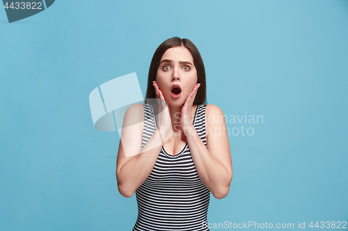 Image of Beautiful woman looking suprised isolated on blue