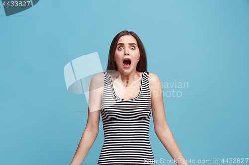 Image of Portrait of the scared woman on blue