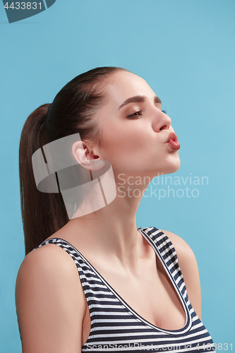 Image of The young woman is looking lovely on the blue background.