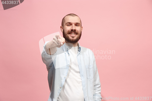 Image of The happy business man point you and want you, half length closeup portrait on pink background.