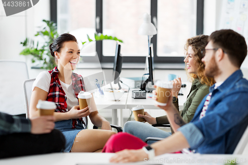 Image of creative team drinking coffee at office