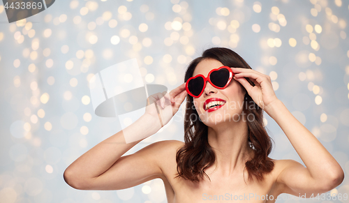 Image of woman with red lipstick and heart shaped shades