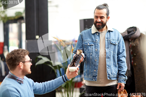 Image of friends choosing shoes at vintage clothing store