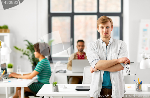 Image of man with glasses at office