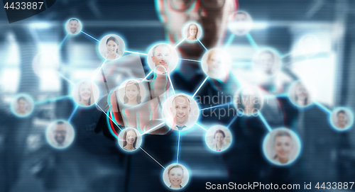 Image of businessman working with network contacts icons