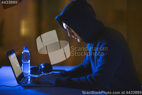 Image of hacker using laptop computer for cyber attack