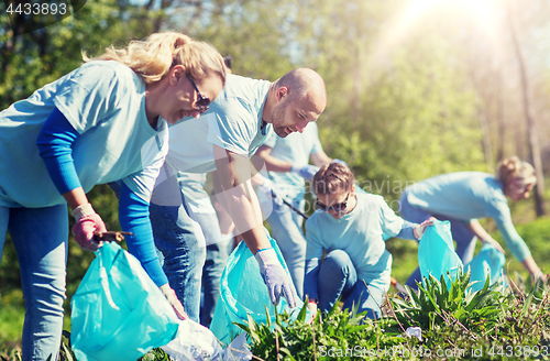 Image of volunteers with garbage bags cleaning park area