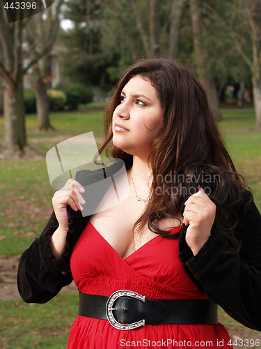 Image of Large young woman in red dress outdoors