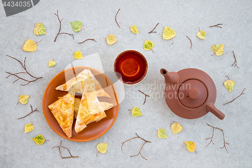 Image of Tea, pastries and autumn leaves