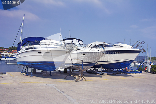 Image of Luxury motor yachts at shipyard waiting for maintenance and repa