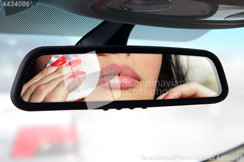 Image of driver make a makeup in car