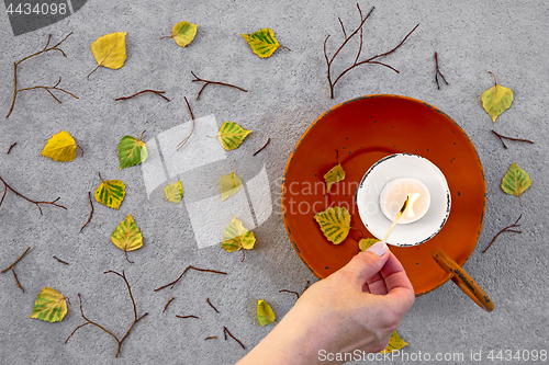 Image of Lighting a candle for cozy autumn mood
