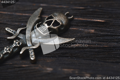 Image of Vintage skull and pirate key on a wooden table