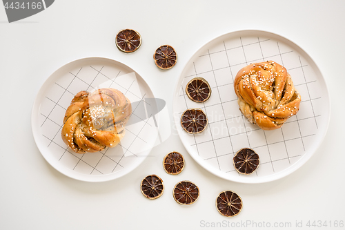 Image of Cardamom buns decorated with dried lemon slices
