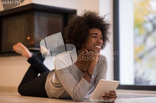 Image of black women using tablet computer on the floor