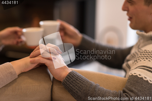 Image of Young couple  in front of fireplace