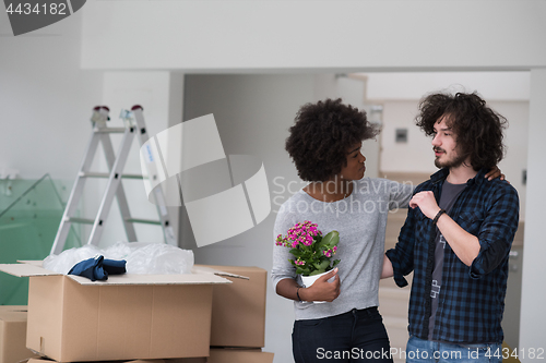 Image of multiethnic couple moving into a new home